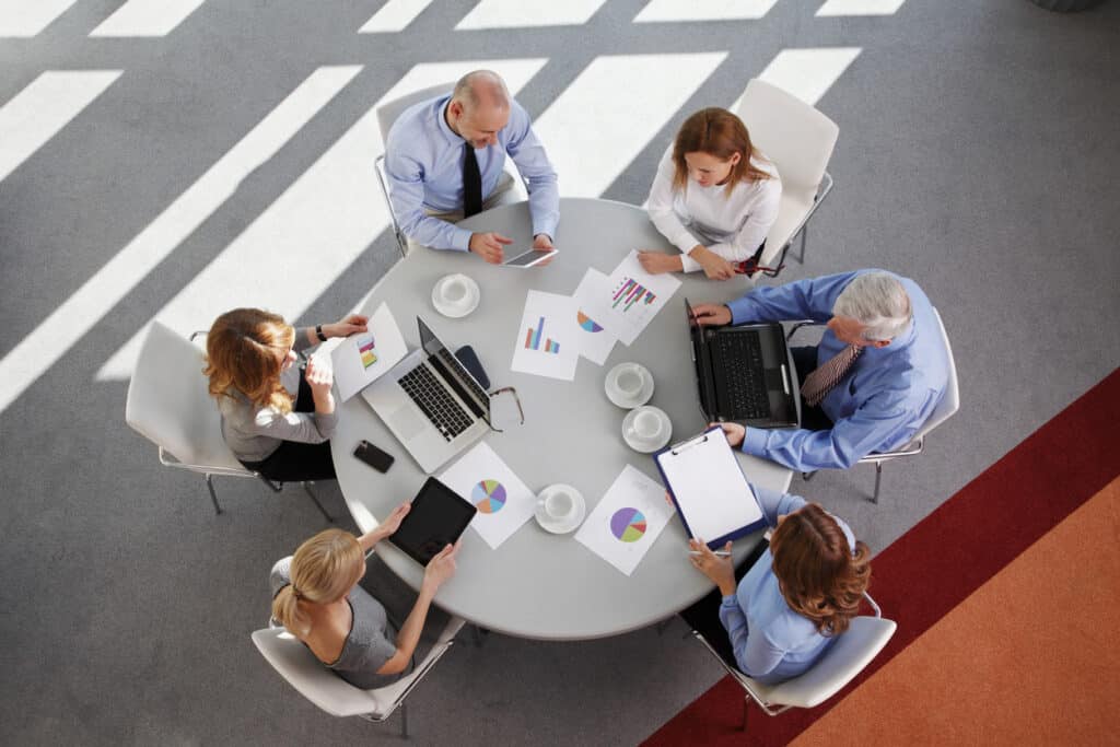 overhead shot of collaborative leadership around a table
